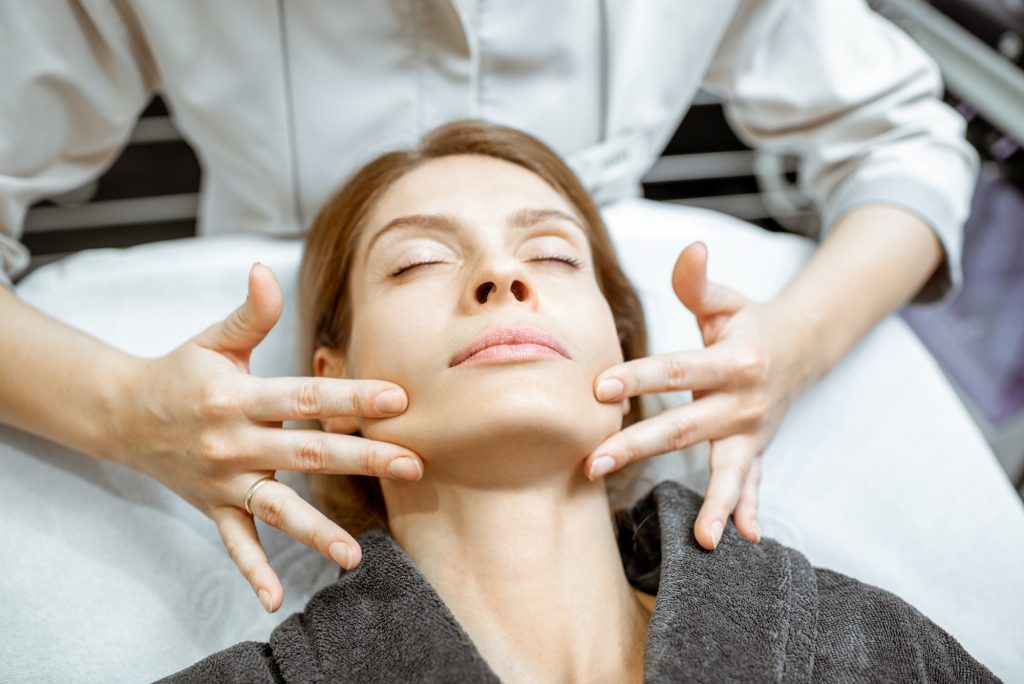 Woman during the facial massage at the beaty salon